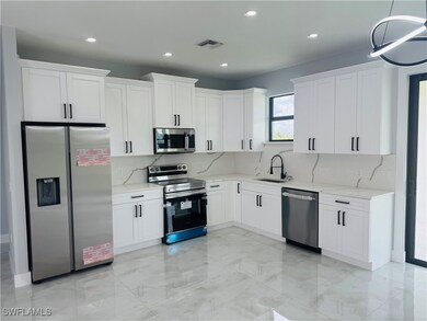 Kitchen featuring stainless steel appliances, ligh