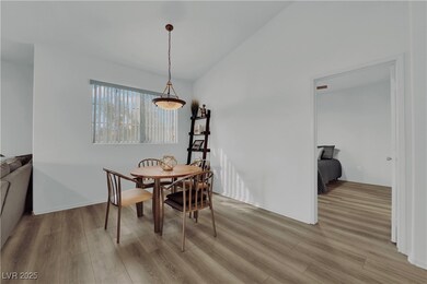 Dining room with light wood-style floors and vault