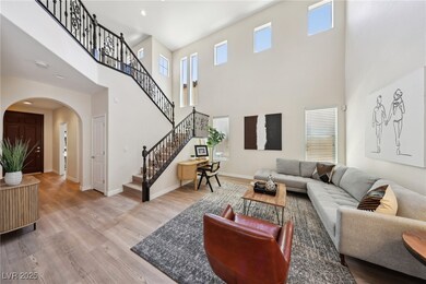Living room with arched walkways, a towering ceili