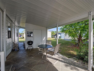 EXTENDED CARPORT USE AS SITTING AREA OR ROOM FOR SEVERAL CARS.