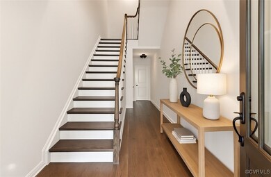 Stairway with wood finished floors and baseboards