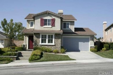 The stone facade, perfectly manicured yard, and pr
