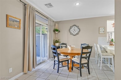 Dining room with visible vents, baseboards, and li