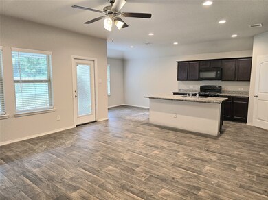 Spacious open-concept living area with modern kitc