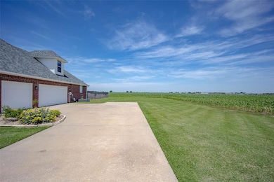 View of green lawn with driveway, agricultural are