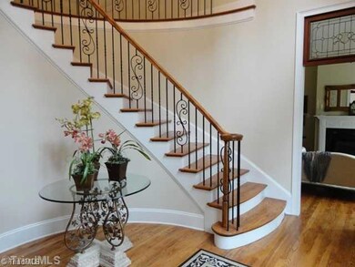 Entry. Winding staircase set the stage for this upscale property