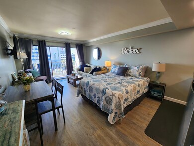 Bedroom with access to outside, ornamental molding, and wood finished floors