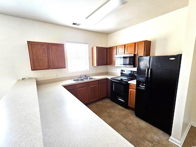 Kitchen featuring sink and black appliances