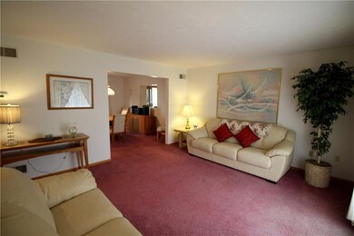 Another view of living room, open to dining room.