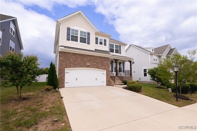 View of front of home with a garage and a front la