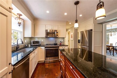 The newly renovated white kitchen features granite