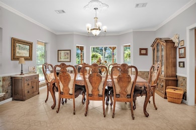 Expansive dining room flooded with natural light, offering direct access to the kitchen for effortless entertaining.