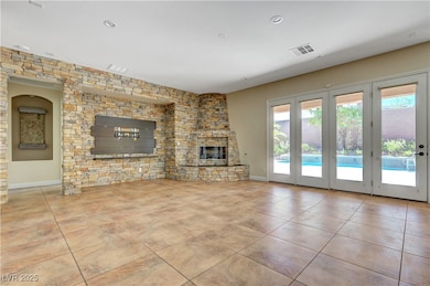 Unfurnished living room with a glass covered firep
