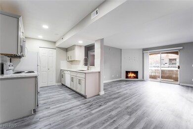 Kitchen with sink, tasteful backsplash, and light wood-type flooring