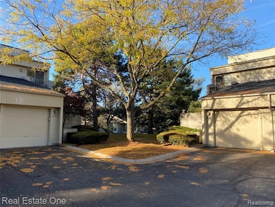 View of yard with a garage and driveway