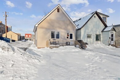 View of snow covered rear of property