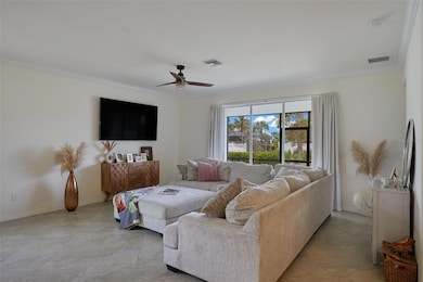 Living Room. Patio Sliders open to screened lanai and landscaped area.