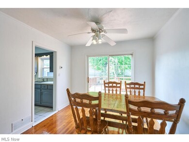 Dining room with sink, ornamental molding, ceiling fan, and light wood-type flooring