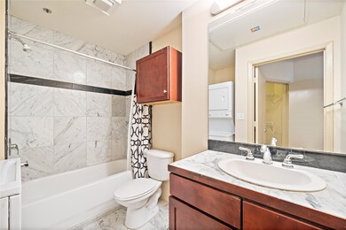 Full bathroom with tub, shower combination.