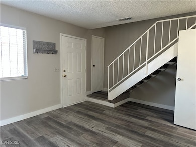 Entrance foyer featuring stairs, a textured ceilin