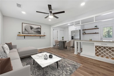 Living room featuring wood finished floors, ceiling fan, recessed lighting, and baseboards
