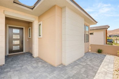 View of exterior entry featuring a patio and stucc