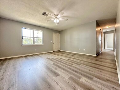 Unfurnished room with ceiling fan, a textured ceil