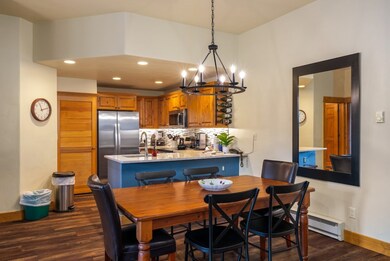 Dining space with sink, dark wood-type flooring, a