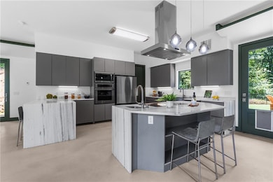 Kithen with flat panel cabinetry and stainless appliances including induction cooktop.