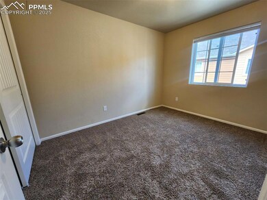 Spare room with carpet floors, baseboards, and visible vents