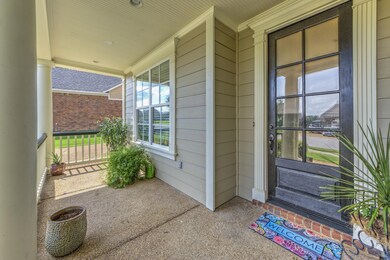 Doorway to property with covered porch