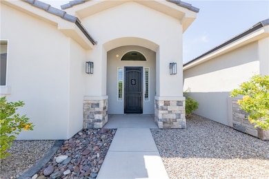 Doorway to property with stucco siding and stone s
