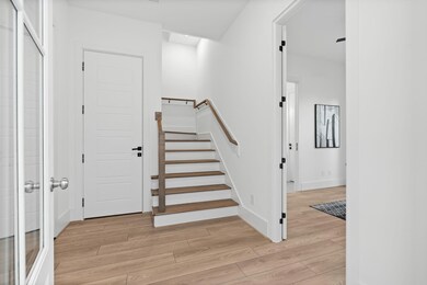 Bright and modern entryway featuring light wood fl