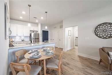 Kitchen featuring white cabinetry, light hardwood