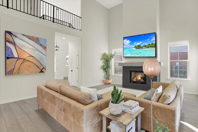 Living room featuring a high ceiling and hardwood / wood-style floors