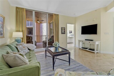 Living room with ceiling fan and ornamental moldin