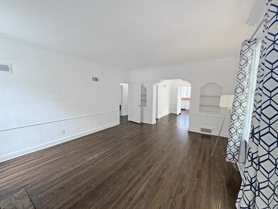 Unfurnished living room with dark hardwood / wood-