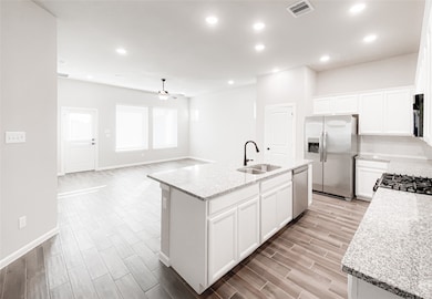 Kitchen is open to the spacious family room with recess lights and lots of natural light