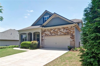 Craftsman-style home featuring stone siding, an at