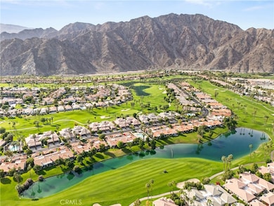 Aerial view above condo with view of fairway and Santa Rosa Mountains