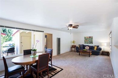 Dining area and living room with fan. Entrance to 