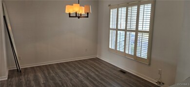 Dining area with LVP flooring, and an inviting chandelier
