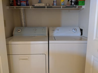 Laundry room with washing machine and clothes dryer