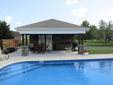Custom built pool house with bath, storage and custom cabinets with sink.