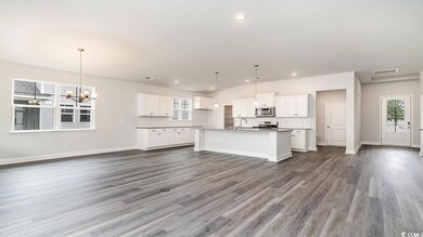 Kitchen featuring white cabinetry, a center island