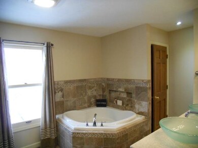 Whirlpool tub with tile surround creates a perfect