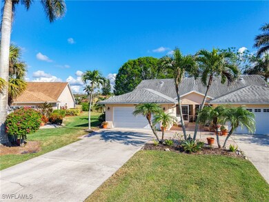 View of front of home with a garage and a front ya