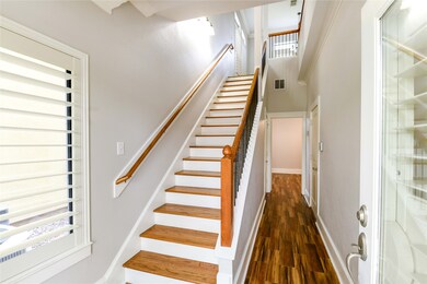 Beautiful, freshly painted entry with brand new wood tile flooring.