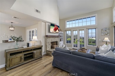 The perfect living area with French Doors to the outside, luxury vinyl tile floors, cozy fireplace and high ceilings.