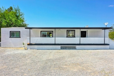 Rear view of property featuring stucco siding